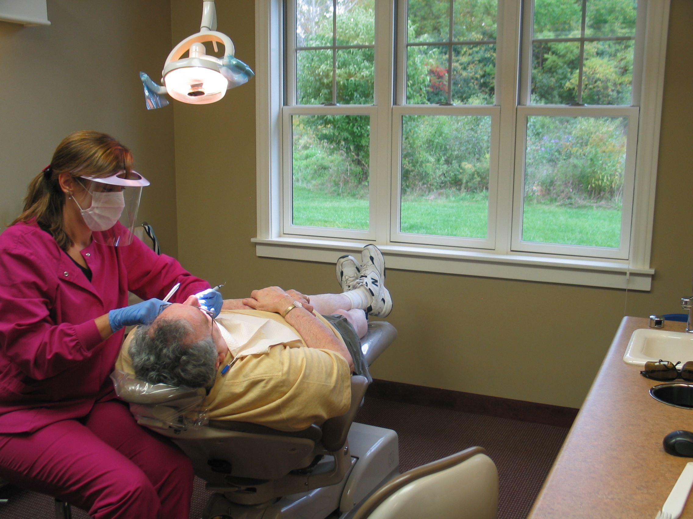 Assistant Working on Patient